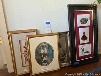 Three framed mixed media artworks including one with birds, one Hawaiian art piece, and a floral piece.