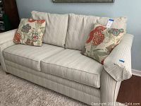 Full front view of sofa with cushions and accent pillows