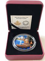 Coin and certificate displayed in pink clamshell box with black velvet interior
