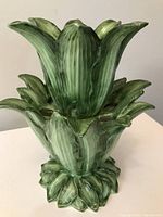 Front side view showing the stacked leaf design of the green glazed ceramic epergne