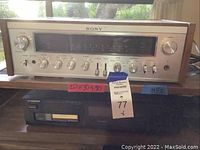 Front view showing Sony receiver with multiple silver control knobs and large display above a black Pioneer DVD player with digital display and disc tray.