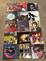 Overview of all 16 vinyl album covers laid out on floor
