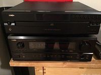 Overview of both Denon units stacked on a shelf