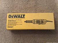 Front of unopened DeWalt box labeled Heavy-Duty 1-1/2" (38 mm) Straight Grinder and model DW887