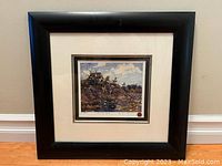 Framed art print showing the entire piece including black frame, cream matting with black inner border, and the print centered depicting a wooded pond scene.