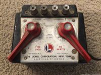 Front view of Lionel Transformer Type 100 showing red control knobs, terminal posts, and branding.