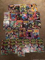 Photo of various Marvel comics arranged on floor showing characters such as The Thing, Fantastic Four, Doctor Strange, Spider-Man, Spider-Man Paladin