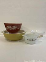 Wide view of all four bowls, showing grouping and relative sizes and designs.
