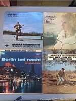 Photo showing four vintage vinyl record album covers: George Hamilton IV's 'Out West Together', Tammy Wynette's 'Tammy's Greatest Hits', Berlin bei Nacht, and Marty Robbins' 'The Return of the Gunfighter'.