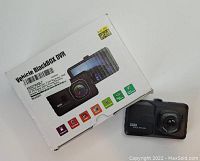 Photo showing the Vehicle Blackbox DVR dash camera next to its original retail box displaying key features and images of the product.