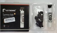 Packaged electric shaver and charging cable with branded box showing product name and key features.