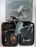 Opened box showing drone, controller, carrying case