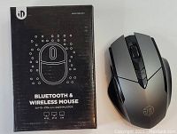 Photo showing the Inphic mouse alongside its original black packaging box labeled Bluetooth & Wireless Mouse with 3 mode connectivity icons.