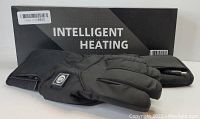 Image shows a pair of black lightly padded rechargeable heated gloves by Intelligent Heating, with box in background.