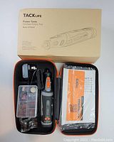 Photo showing the TackLife cordless rotary tool and accessories including charger, attachments box, case, and user manual.