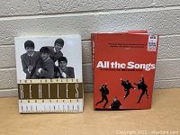 Front covers of two Beatles books showing titles and cover images including a sticker price on one book.