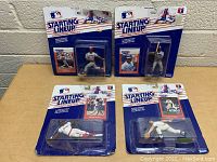 Four MLB Starting Lineup figures in original packaging arranged on a flat surface.