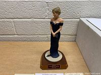 Princess Diana porcelain figurine in dark evening gown on wooden base with plaque