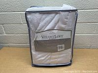 Velvetloft cream twin blanket in original clear packaging with label visible