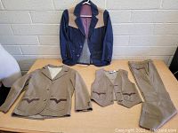Full view of the boys 3 piece suit including jacket, vest, pants and the separate western denim jacket.