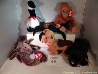 Lot of six TY Beanie Babies plush with original tags including goose, spider, monkey, dog, lobster and panther.