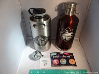 Front view of growlers, bicycle bell, and Belgian food pins