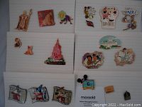 Full lot showing all 16 colorful Disney pins arranged on white pin boards.