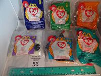 Five unopened McDonald's Beanie Babies in sealed plastic packaging with original tags.
