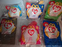 Five unopened McDonald's Ty Beanie Babies in sealed plastic bags with McDonald's and Ty logos visible