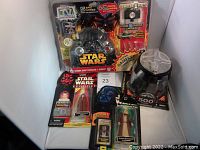Photo showing the Star Wars game controller plus three Star Wars action figures including Darth Maul, Obi-Wan Kenobi, and the 500th figure Darth Vader collectible.