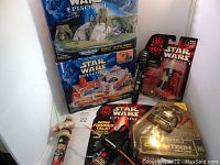 Photo showing all items including boxed Micro Machines playsets, PEZ dispensers, and electronic COMTECH reader.