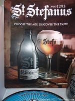 Close view of one St. Stefanus beer sign showing bottle, chalice and tagline