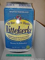 Front view of the metal sign shaped like a blue beer can with Wittekerke branding from Belgium, showing detailed logo, text, and graphics.