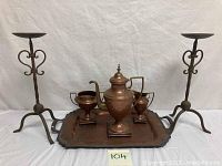 Full set of copper coffeepot, creamer, sugar bowl, and tray with two wrought iron candle holders shown.
