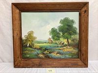 Full view of the framed oil on canvas landscape painting showing trees, cabin, and meadow