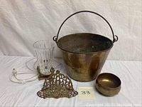 Photo showing all items together: Randolf Clowe signed brass bucket, brass napkin holder, brass footed bowl, and small lamp with glass body.