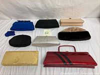 Photo showing grouped collection of nine vintage ladies purses varying in color and texture, plus a beige and dark brown fur hat or tam.