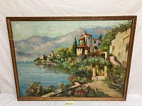 Full front view of framed oil painting depicting Mediterranean scene
