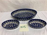 Full set of three Boleslawiec Polish Pottery serving bowls in peacock pattern, shown side by side.