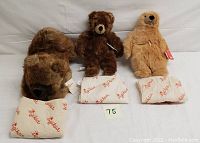 Three vintage Sigikid plush toys: two bears and one gopher, laid out with Sigikid wrapping material and a lot number card.