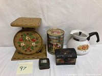 Group photo showing vintage kitchen scale, two decorative tins, a small ornate box, and Corningware teapot.