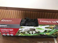 Photo of the original box showing Quest Club Level Volleyball and Badminton Combo Set branding and partial visible contents.