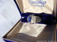 Ring displayed in blue velvet-lined box with Courtship Diamonds branding