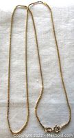 Full view of the box chain necklace laid flat
