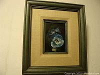 Framed floral oil painting hanging on wall, showing overall view with wooden frame and beige matting.