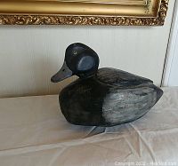 Side view of the hand carved duck decoy showing detailed head and body shape