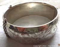 Close-up of the engraved floral pattern and Forstner sterling mark inside the bangle, showing detail and authenticity.