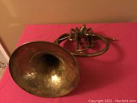 Top angle view of the brass mellophone showing the bell and tubing.