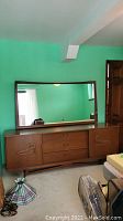 Straight-on view of dresser with mirror.
