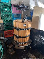 Front view of oak barrel with cast iron top screw mechanism